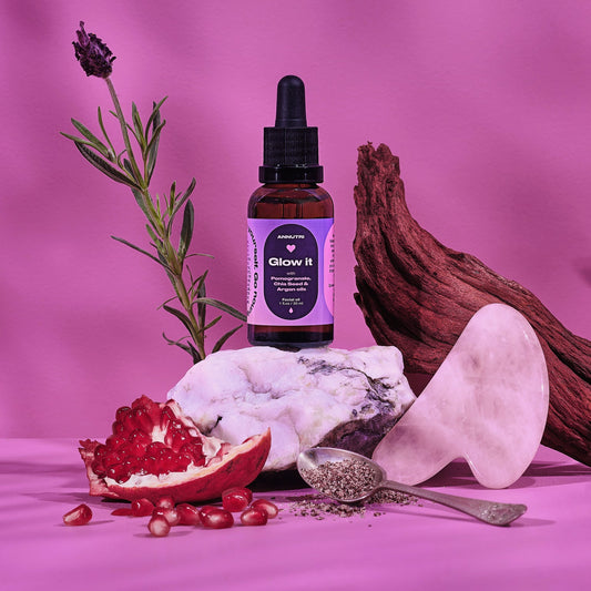 Bottle labeled 'Glow It' with natural elements on a pink background