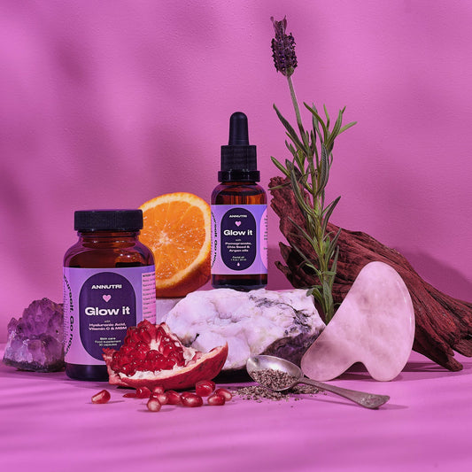 Supplement bottles labeled 'Glow it' with natural elements on a pink background