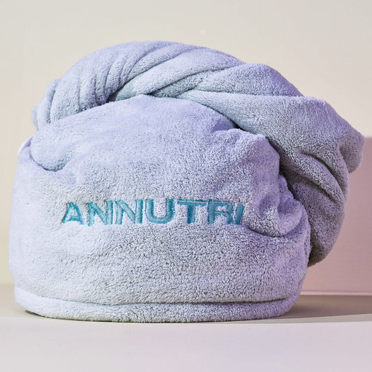 Light Teal Microfibre towel branded with 'ANNUTRI' branding on a light background