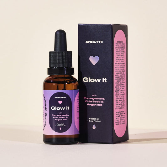 Amntri Glow it facial oil bottle and packaging on a light background