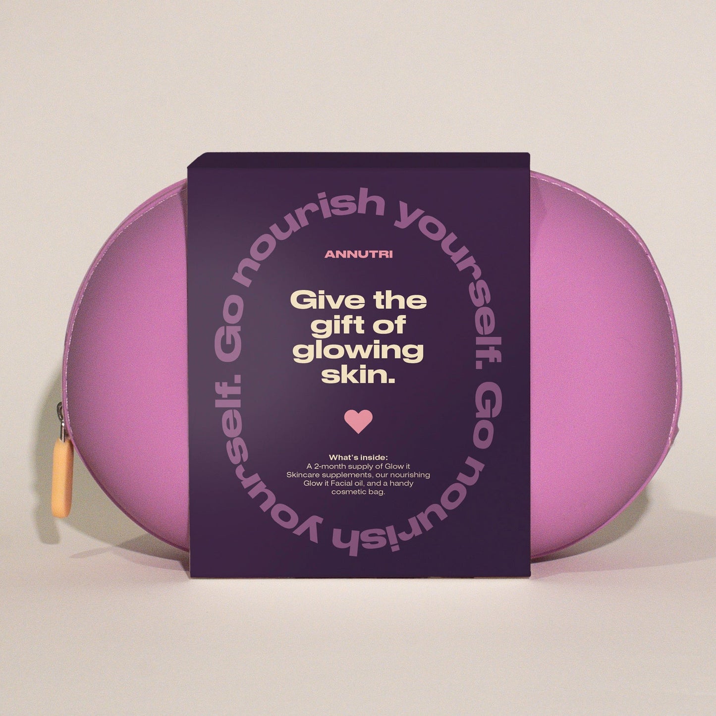 Purple skincare product with a card reading 'Give the gift of glowing skin' on a light gray background