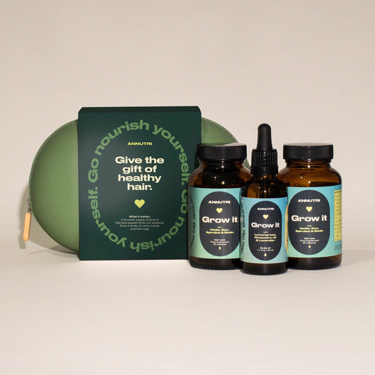 Hair care product set with bottles and a box on a light background