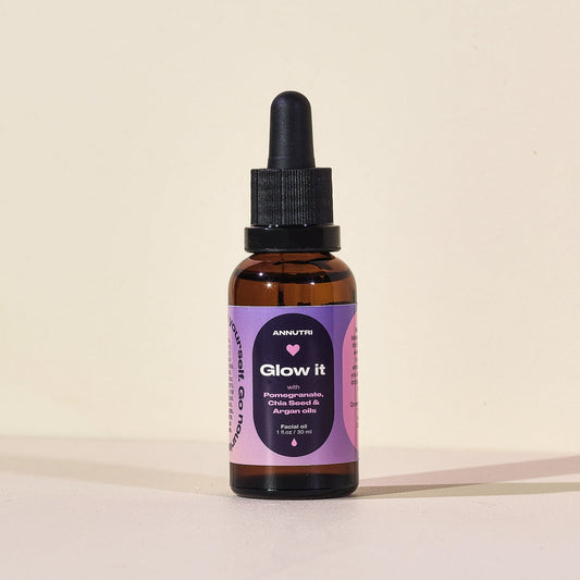 Bottle of 'Glow it' skincare serum with a purple label on a beige background